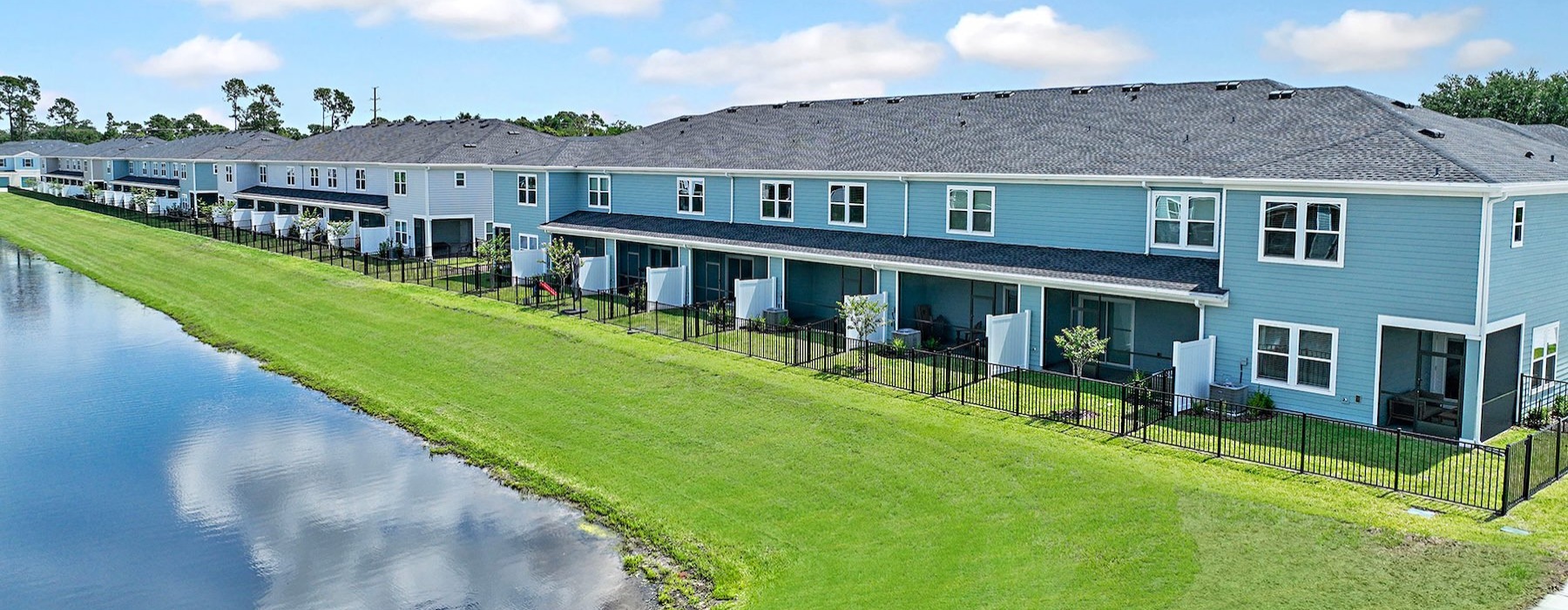 a row of houses next to a body of water