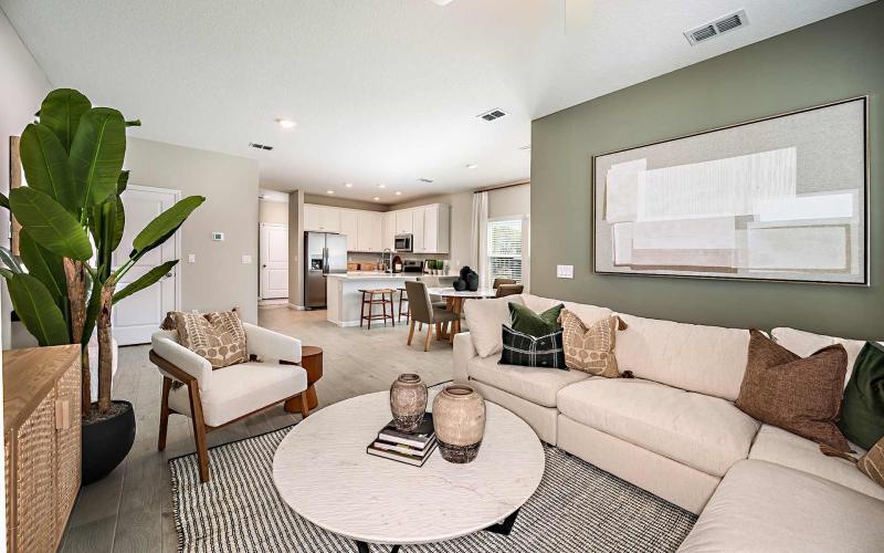 a living room with a large couch coffeetable and chair